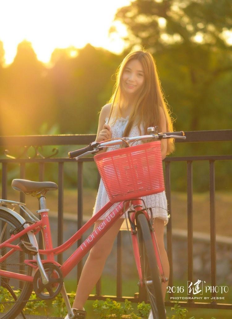 夕阳下骑单车的清纯性感美女图片